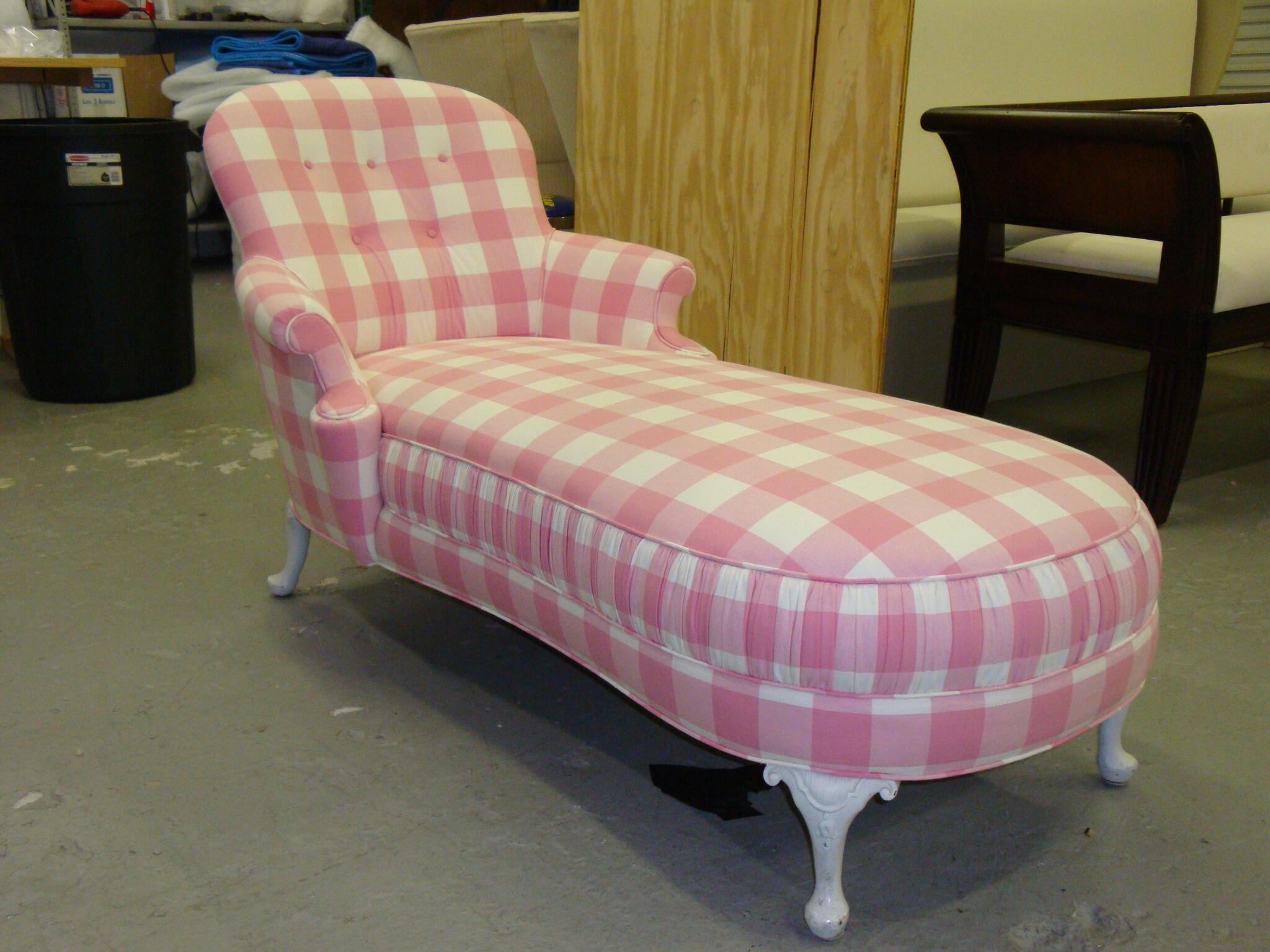 Pink gingham chaise with curved back and white carved feet